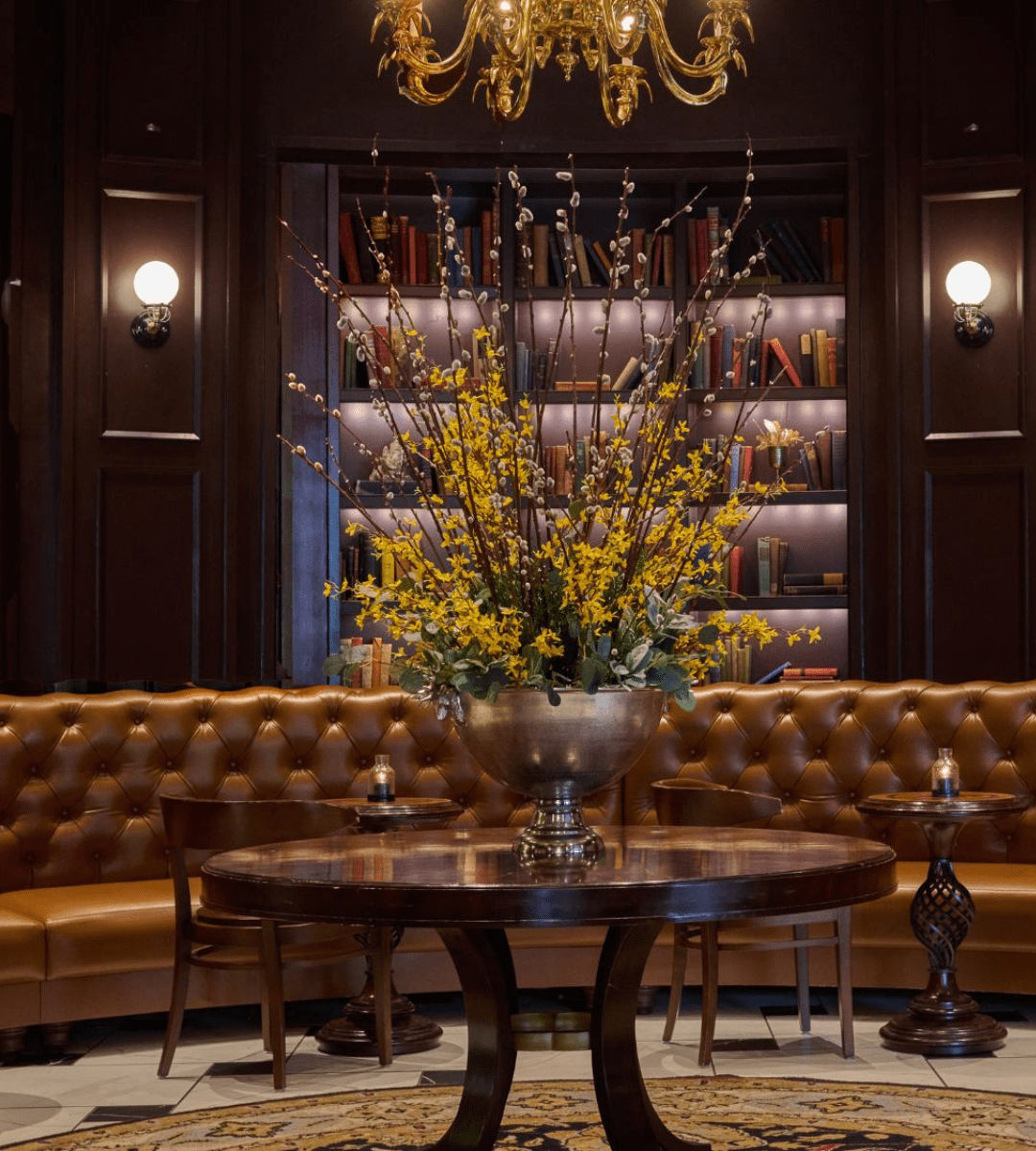 Brown seating area with floral centerpiece at a Harford hotel, The Goodwin